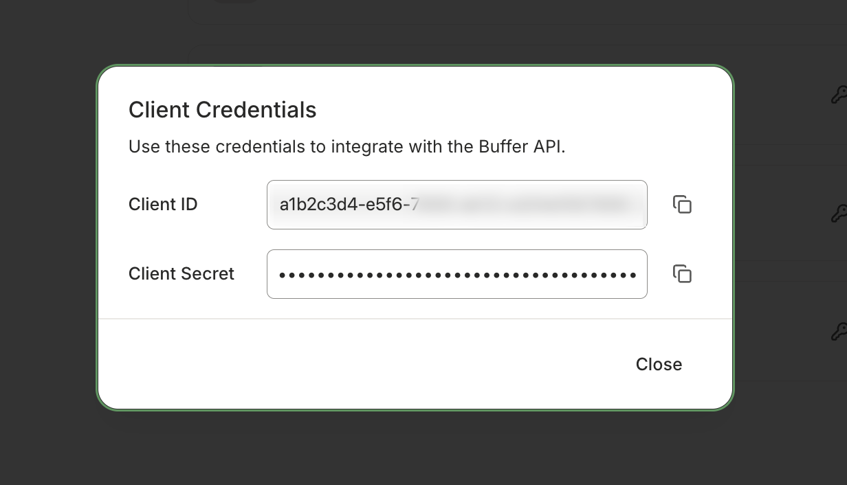 A Client Credentials dialog showing a partly hidden client ID and a masked client secret, each with a copy button